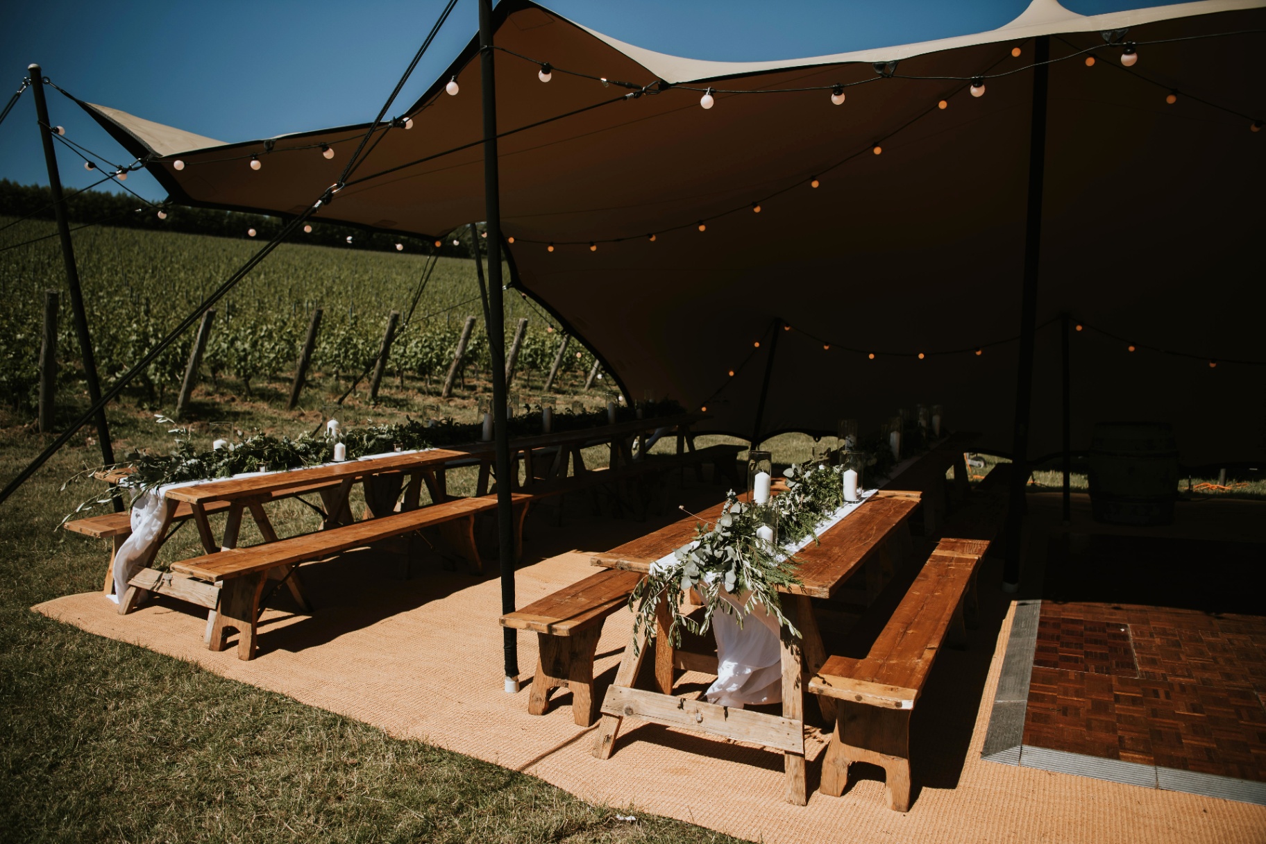 Small stretch tent with banquet tables underneath