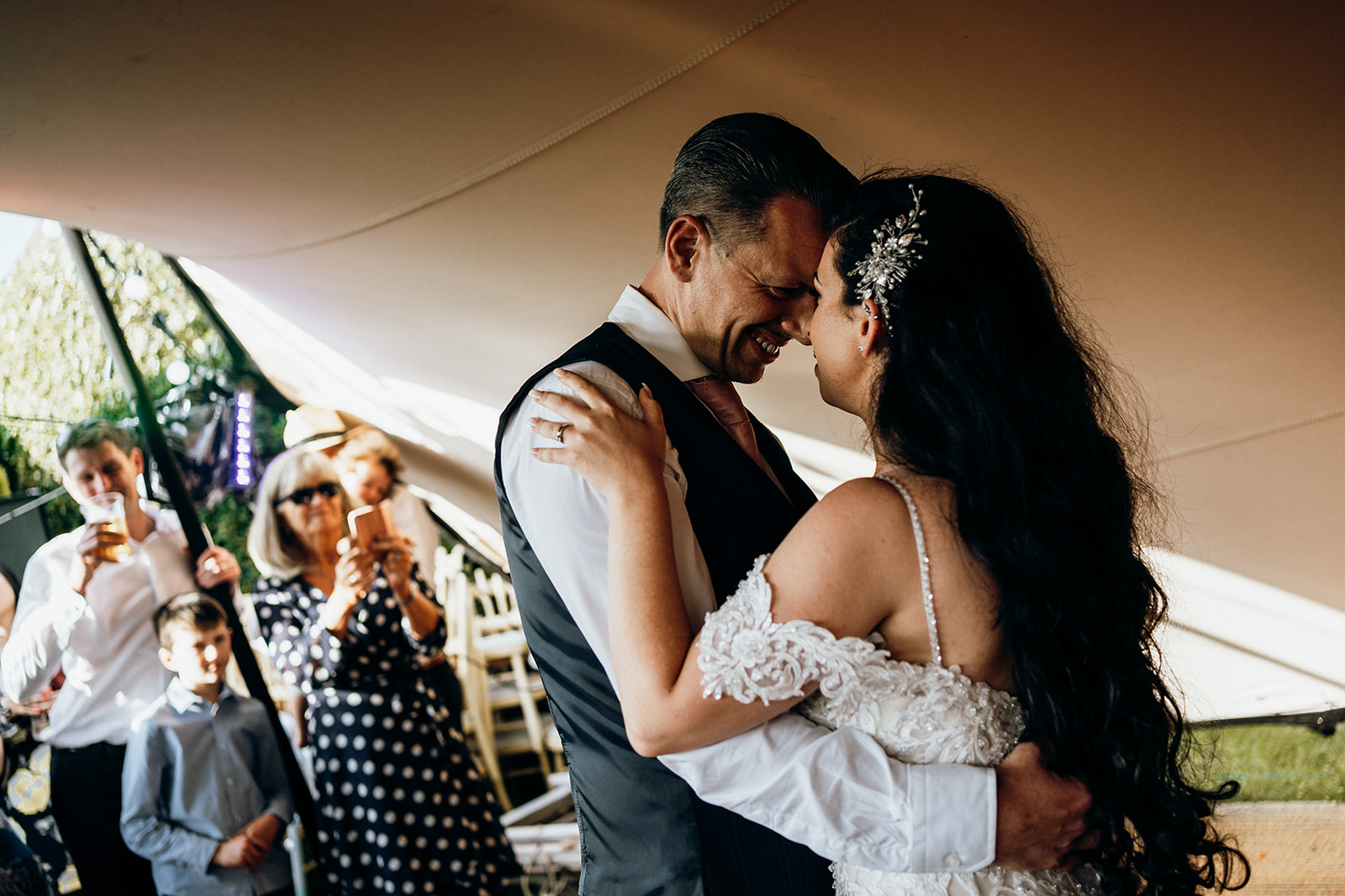 Couple sharing their first dance under the stretch tent