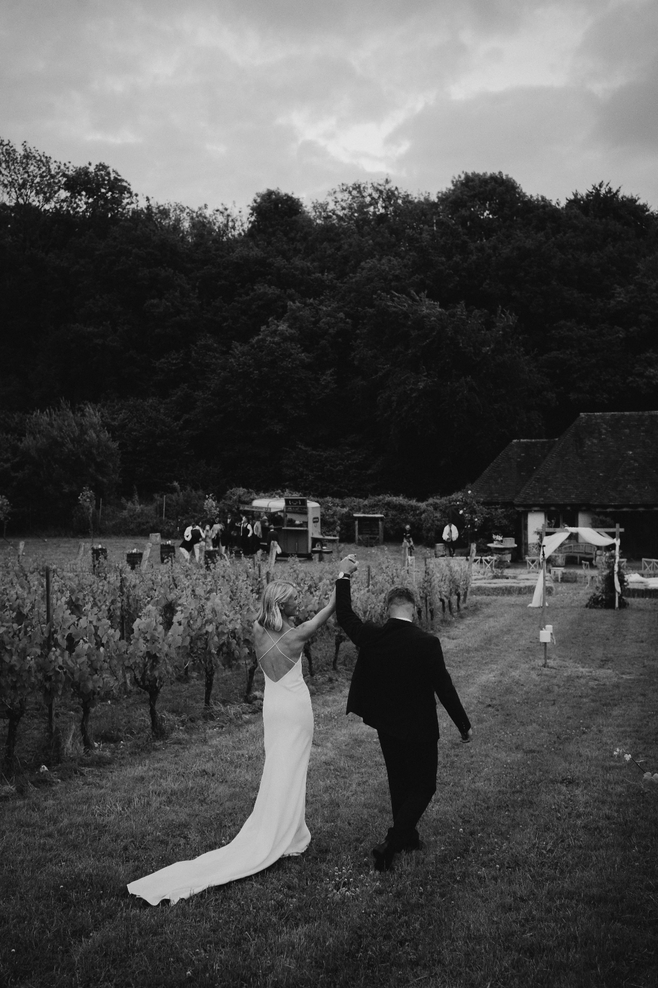 Couple dancing in the vineyard beside the stretch tent