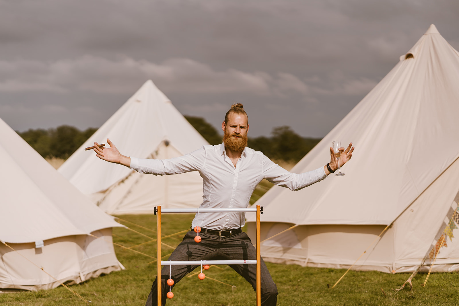 Guest celebrating in front of the bell tents