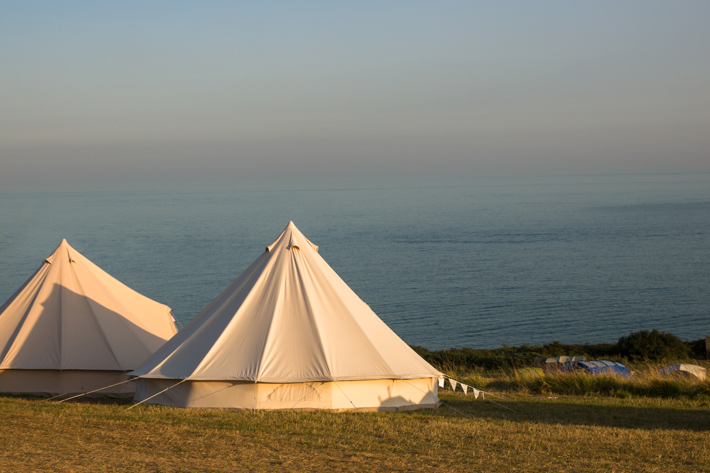 Bell tents at sunset by the sea