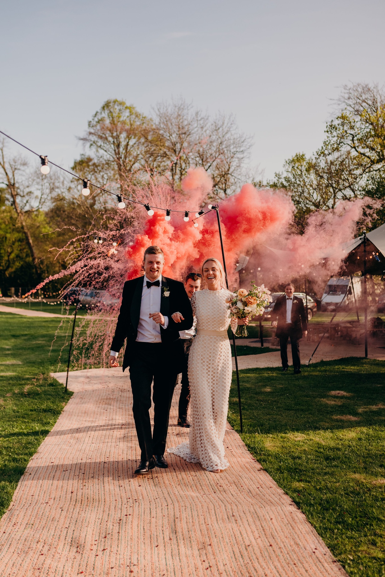 Stretch tent wedding lit with festoons at dusk on Guernsey