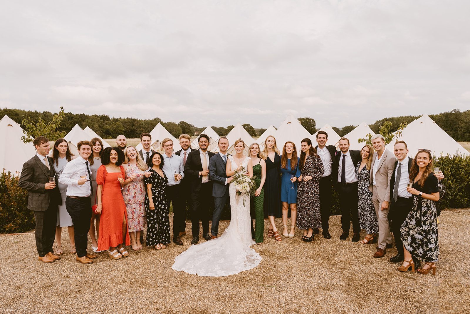 Wedding party in front of the bell tent village