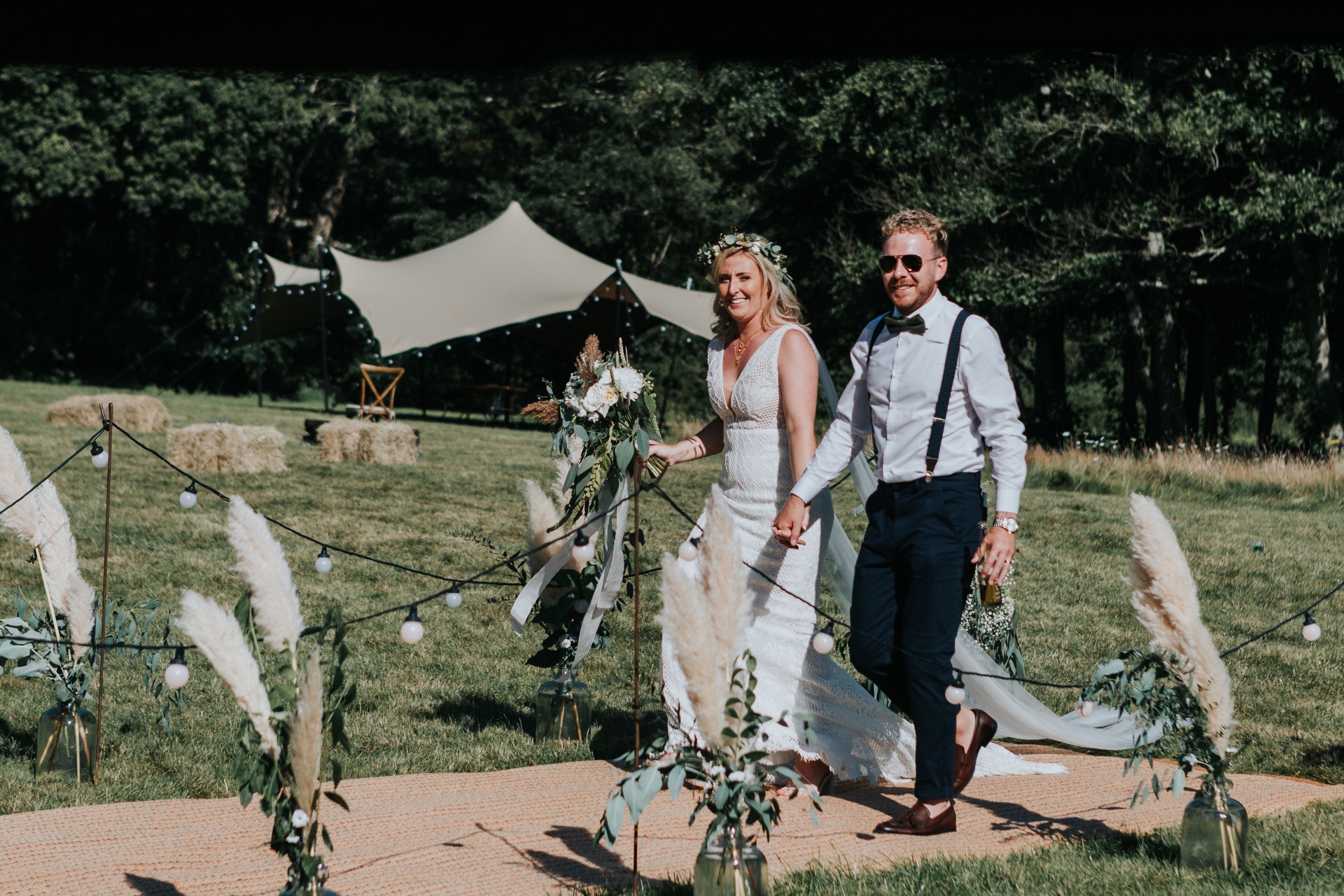 Wedding couple under a stretch tent by a pond